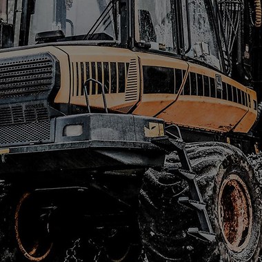 yellow construction machine in a forest