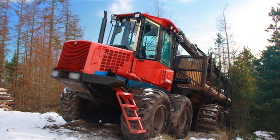 red forestry machine in a forest