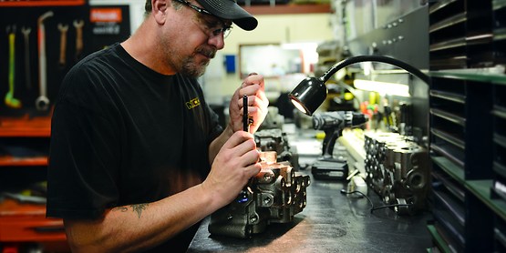 man in a black shirt working on a brake component